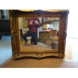 A large wood & gesso rectangular gilt framed hanging wall mirror