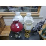 Three Brass Oil Lamps with Glass Shades and another Oil Lamp with Red Glass Shade