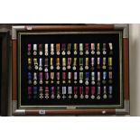 Framed set of sixty Danbury Mint miniature medals & booklet