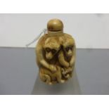Bone snuff bottle with three primates carved to side