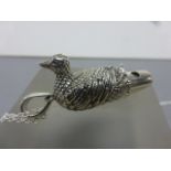 A novelty whistle in the form of a duck on a silver chain