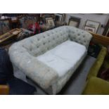 An Edwardian upholstered button back Chesterfield settee