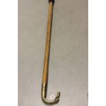 Wooden walking stick with brass duck handle