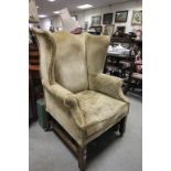 Edwardian upholstered oak framed wingback armchair on brass castors