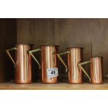 Set of Four Graduating Copper Hanging Cup Measures with Brass Rail