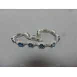 A silver, CZ & blue topaz daisy style bracelet