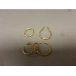 Two pairs of unmarked; possibly 9ct yellow gold hoop earrings