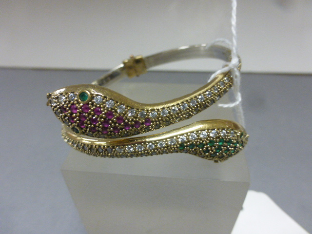 A silver double snake bangle inset with semi-precious stones