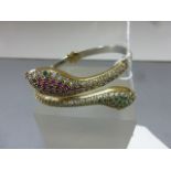 A silver double snake bangle inset with semi-precious stones