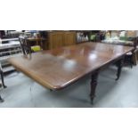 Victorian Mahogany Extending dining table; raised on heavily carved legs; with two additional