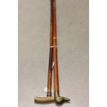 Walking Cane with Horn Handle and Silver Band together with a Walking Stick with Duck Head Handle