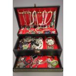 Black three tier jewellery box containing costume jewellery