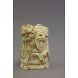 Signed oxbone netsuke of an old man with fan & basket