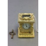 19th C style miniature carriage clock in a gilt case with cherubs to the pillars