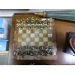 Metal chess set with figures of Roman soldiers on heavy marble board