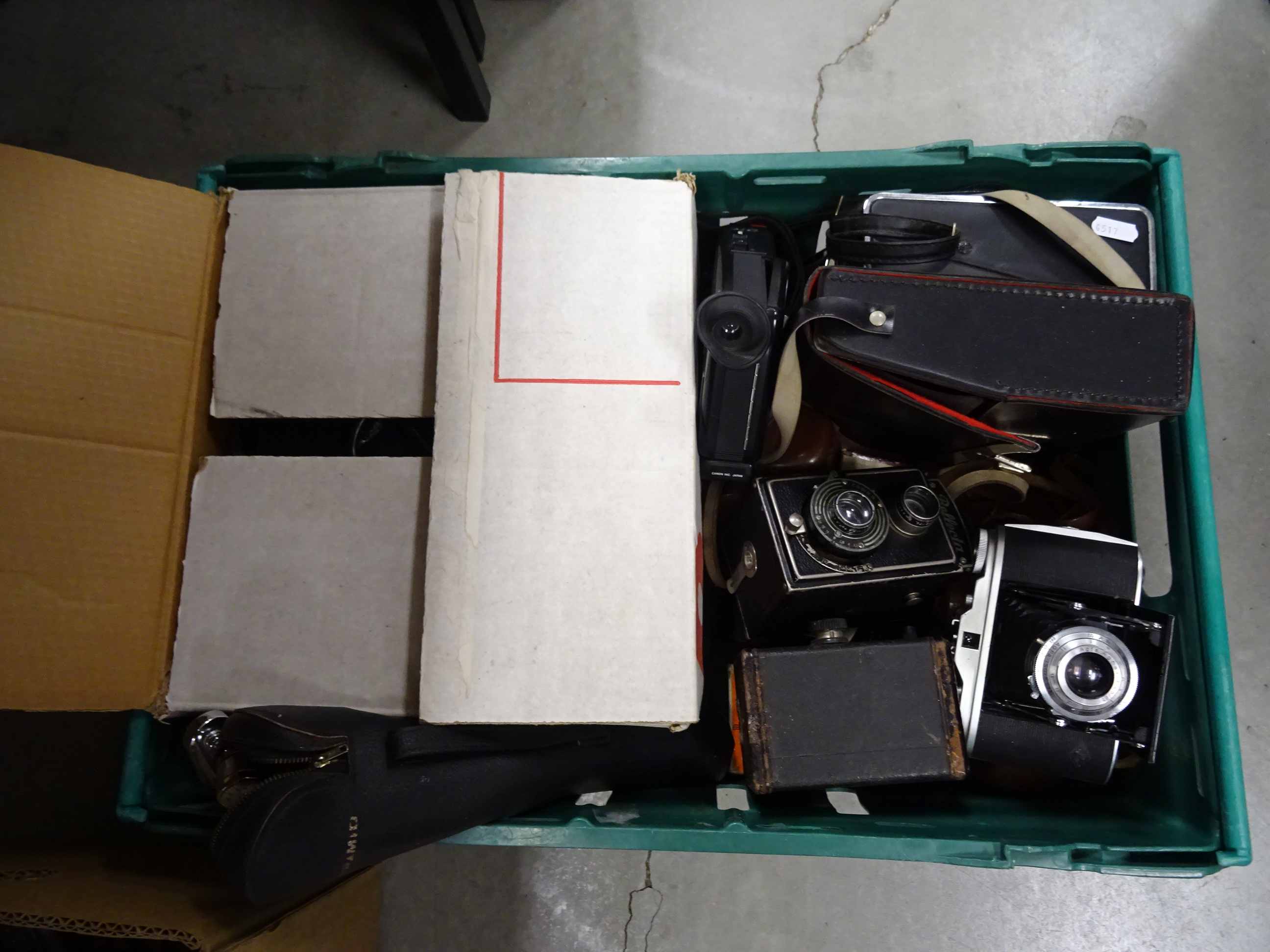 Photography slide projector in box along with a selection of antique cameras including film and cine