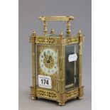 20th C gilt carriage clock with white enamelled dial and black numerals