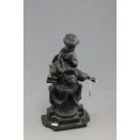 Bronze of a child reading a book