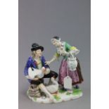 A 19th century Vienna group of a couple feeding geese