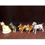 Four Beswick dogs to include Dalmation, Alsatian and 2 Corgi's plus a Royal Doulton Catkin figure