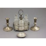 Sterling silver weighted candlesticks, a silver strainer, condiments and stand