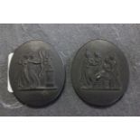 Two 19th century Wedgwood black ceramic oval plaques, stamped Wedgwood to the reverse