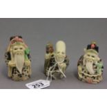 Three netsuke style figures of old men