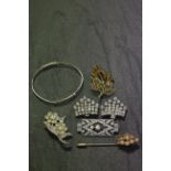 A silver bangle, along with various pieces of costume jewellery