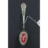 An American silver and enamelled spoon, marked for Charles W. Crankshaw, the handle cast as a