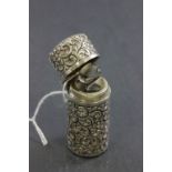 Victorian Silver Scent Bottle with hinged lid and glass stopper, heavily embossed floral decoration,