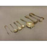 Mix of hallmarked silver cutlery items, including; silver tea strainer, Victorian straining spoon,