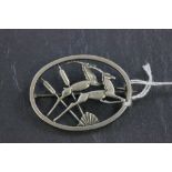 A silver brooch designed by Geoffrey Bellamy, depicting two jumping springboks, Birmingham 1960,