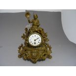 Contintental Gilt Metal Ornate Mantle Clock surmounted with a Seated Bow holding Hat