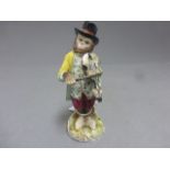 A continental ceramic figure of a monkey playing a violin, with blue crown mark to the base