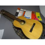 A Suzuki guitar, no 1663, made in Japan, along with various "How to learn" guides