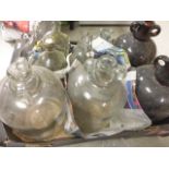 A collection of glass demijohn's, and various other bottles