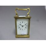 A 20th century French carriage clock, with white enamel dial and Roman numerals