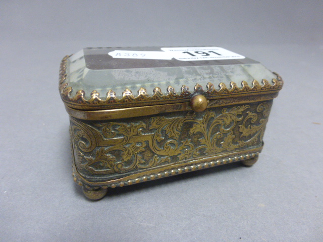 A Victorian brass box, with magnifying bevelled glass lid and engraved decoration