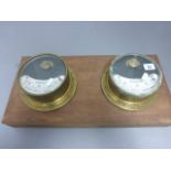 Two vintage Amperes readers, each in a brass case, glass front mounted on a wooden board
