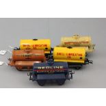 Five Hornby O gauge oil wagons to include Shell Lubrucating Oil x 2, Pratts Motor Spirit, Redline