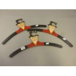 Three vintage wooden coat hangers in the form of a circus ringmaster