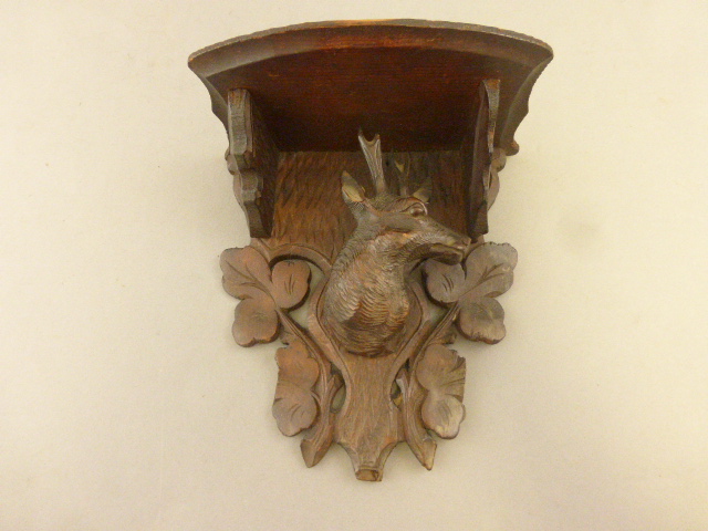 A Black Forest bracket with deer head decoration