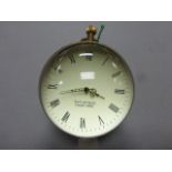 A large brass and glass ball shaped desk clock