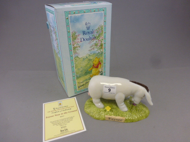 A Royal Doulton Winnie the pooh figure,Eeyore's nose to the ground, boxed