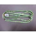 Three Chinese green jade bead necklaces