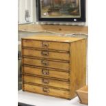 A vintage pine six drawer table top stationary chest