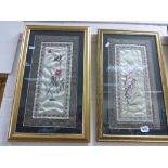 A pair of Oriental hand embroideries on silk depicting birds and flora