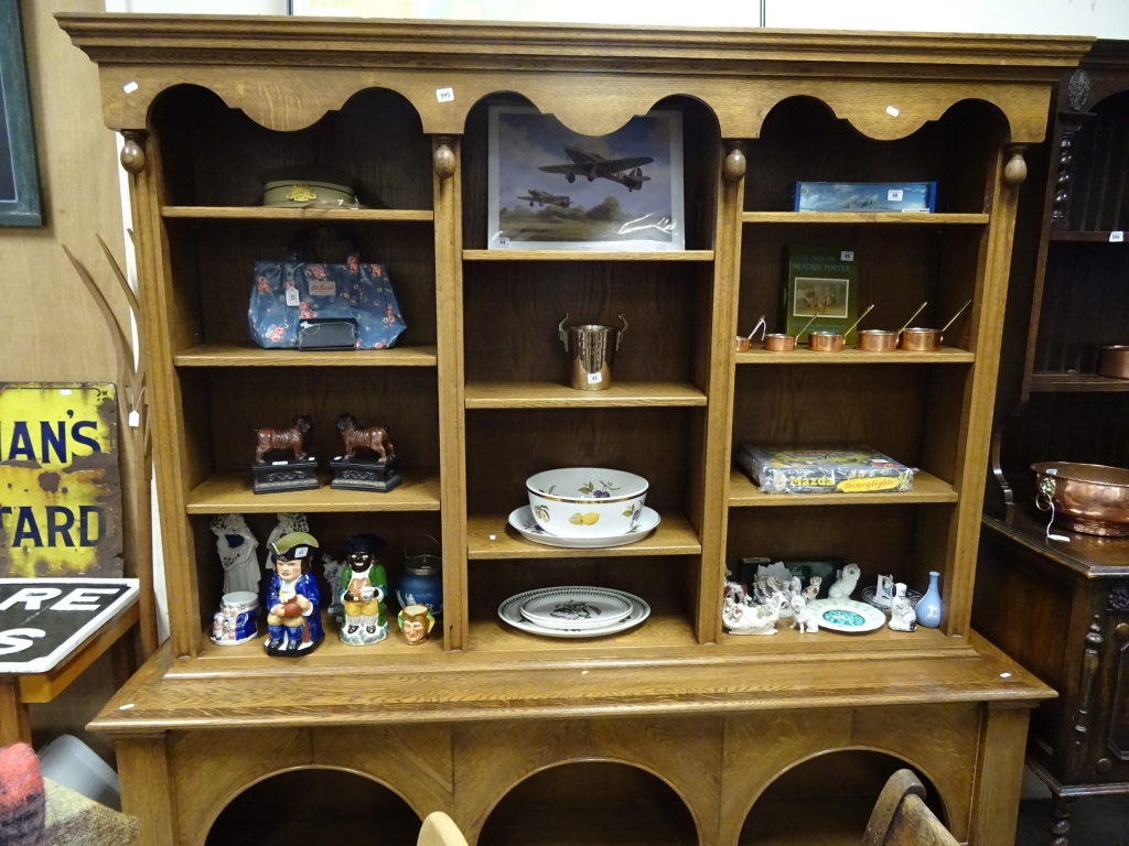A large modern oak dresser, with 3 sections, adjustable shelves and arched base