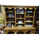 A large modern oak dresser, with 3 sections, adjustable shelves and arched base