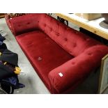 A chesterfield sofa, on turned mahogany legs